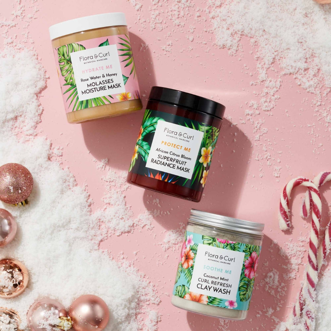 Three hair mask pots on pink Christmas background